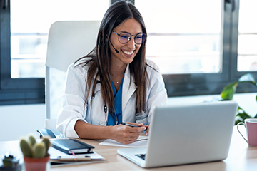 Female doctor talking with colleagues through a video call with Practices and Providers